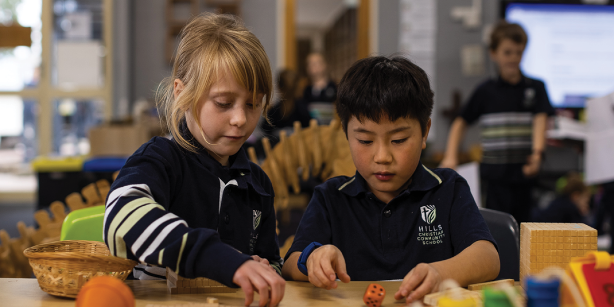 Two students playing with blocks in classroom